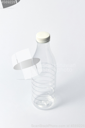 Image of Transparent empty bottle for liquid on a light background. Mock up.