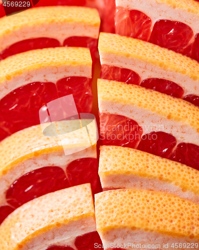 Image of Fresh slices of ripe grapefruit presented in a row. Healthy Diet Fruit. Flat lay