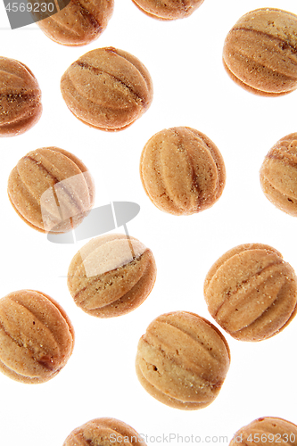 Image of Fresh cakes walnuts pattern on a white background.