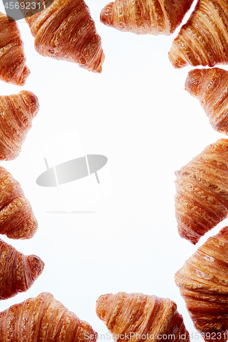 Image of French croissants frame with copy space on a white background.