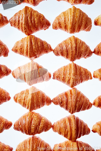 Image of Rhombus french croissants pattern on a light background.