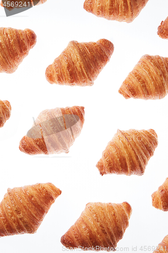 Image of Food pattern with french homemade croissants on a white background.