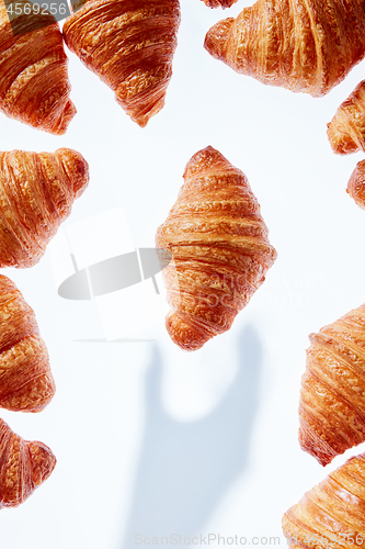 Image of Pastry frame with shadow from hand on a light background.