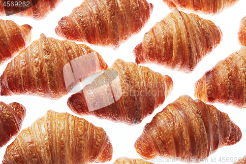 Image of Close up homemade french croissants pattern on a white background.