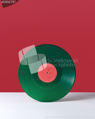 Image of Vinyl retro record on a double red white background with copy space. Audio technology concept