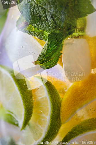 Image of Summer drink glass of lemonade with lime and mint leaf.