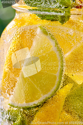 Image of Closeup refreshing mojito cocktail in a glass with lime and mint.