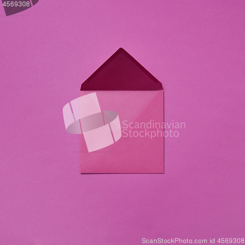 Image of Handmade mockup envelope for post card on a purple background.