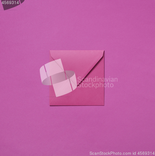 Image of Craft envelope mock-up for invitation on a magenta background.