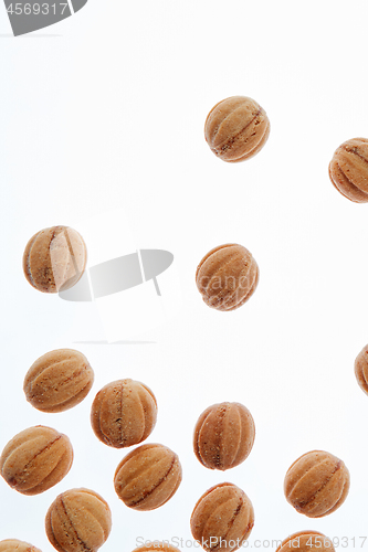 Image of Falling homemade cookies walnuts on a white background.