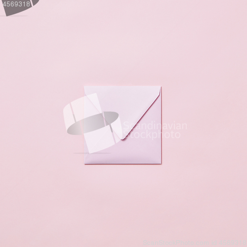 Image of Handcraft envelope mockup for post card on a pastel pink background.