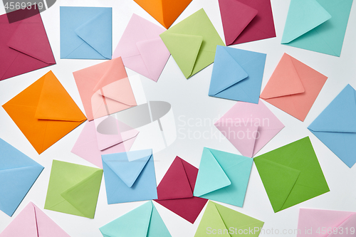 Image of Colorful frame from empty handmade envelopes on a light background.