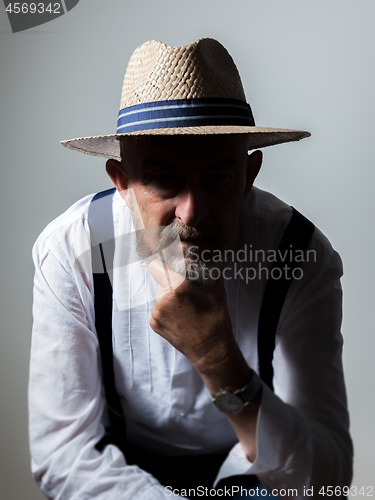 Image of senior male portrait with eyes in dark shadow