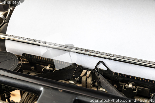 Image of Vintage typewriter with blank sheet of paper retro technology