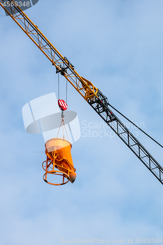 Image of construction crane lifting concrete