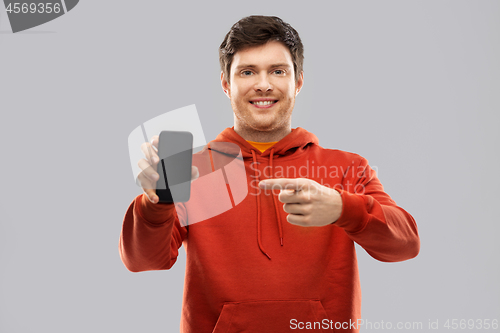 Image of smiling man in red hoodie showing black smartphone