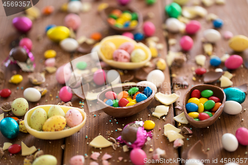 Image of chocolate eggs and candy drops on wooden table