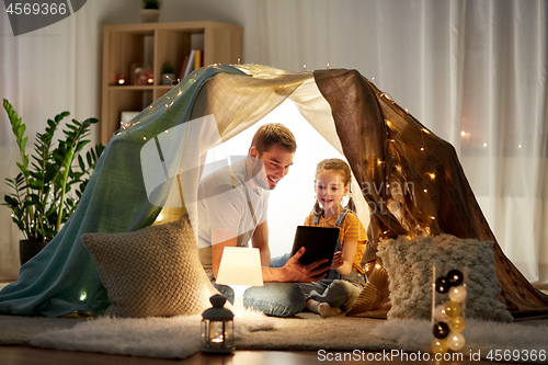 Image of family with tablet pc in kids tent at home