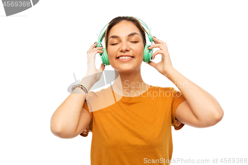 Image of happy young woman or teenage girl with headphones