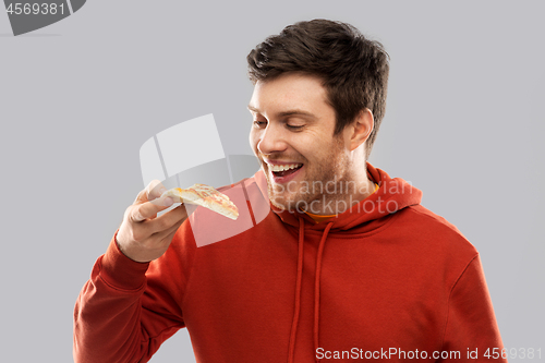 Image of happy young man eating pizza