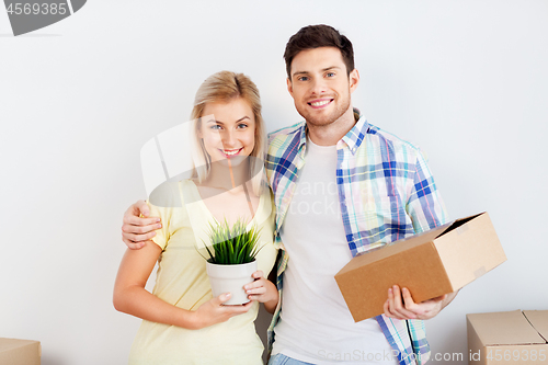 Image of couple with box and flower moving to new home