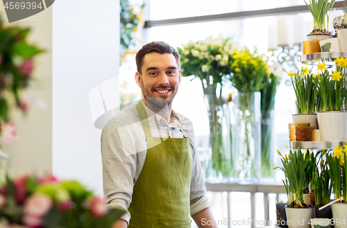 Image of florist man or seller at flower shop counter