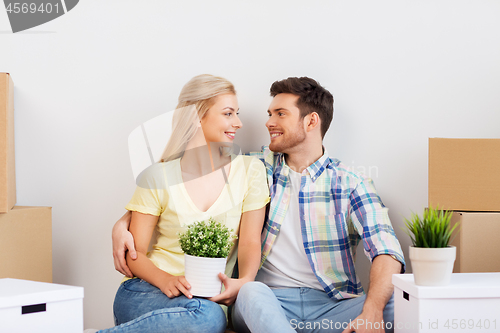 Image of happy couple with boxes moving to new home