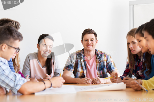 Image of group of smiling students meeting at school