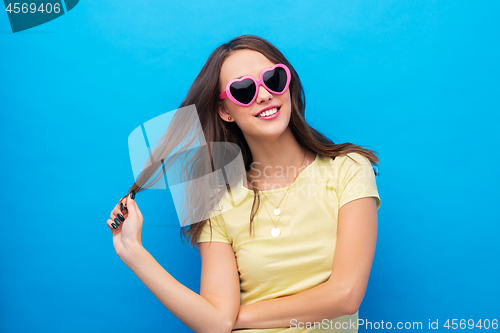 Image of teenage girl in heart-shaped sunglasses