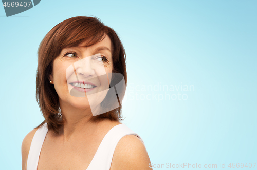 Image of portrait of smiling senior woman over white