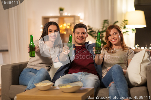 Image of friends toasting non-alcoholic beer at home