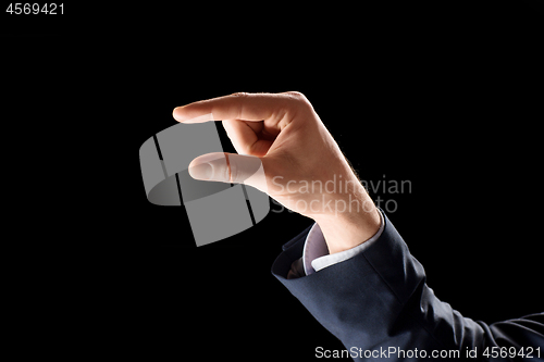 Image of hand of businessman holding something imaginary