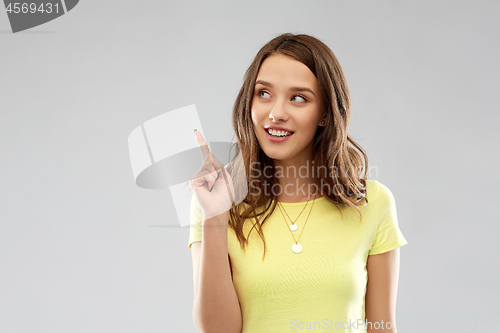 Image of young woman or teenage girl pointing finger up