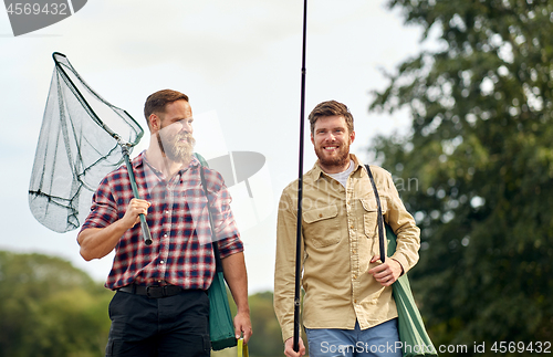 Image of friends with fishing rods and net outdoors