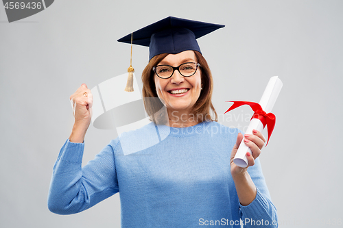 Image of happy senior graduate student woman with diploma