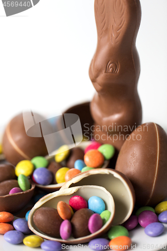 Image of close up of chocolate bunny, eggs and candy drops