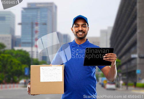 Image of indian delivery man with tablet pc and parcel box