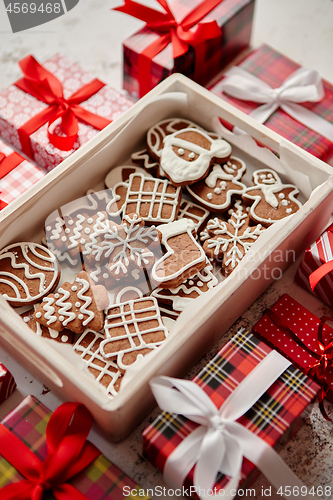 Image of Delicious fresh Christmas decorated gingerbread cookies placed in wooden crate