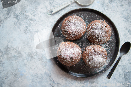 Image of Fresh and tasty chocolate muffins served on plate