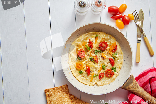 Image of Tasty homemade classic omelet with cherry tomatoes