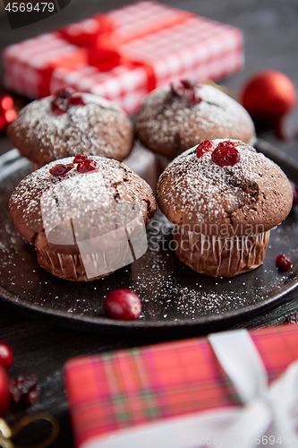 Image of Christmas chocolate delicious muffins served on black ceramic plate