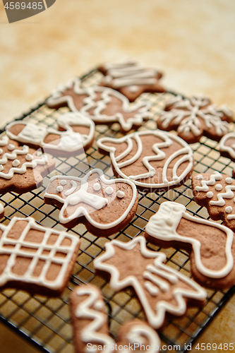 Image of Fresh baked Christmas shaped gingerbread cookies placed on steel grill