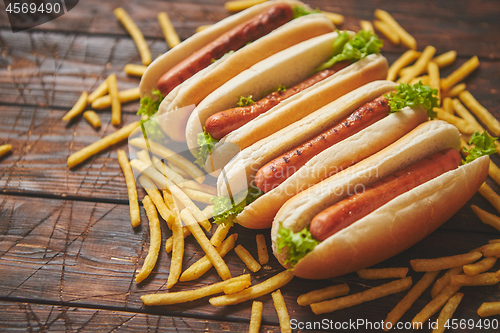 Image of American hot dogs assorted in row. Served with french fries