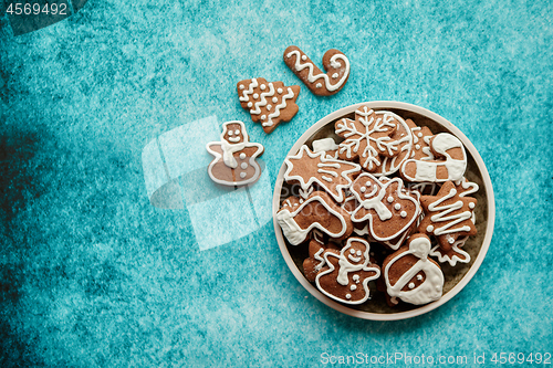 Image of Delicious fresh Christmas decorated gingerbread cookies placed in wooden crate