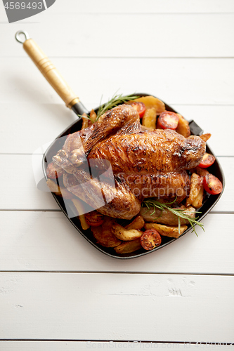 Image of Roasted whole chicken in cast iron black pan