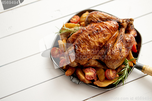 Image of Roasted whole chicken in cast iron black pan