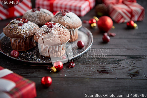 Image of Christmas chocolate delicious muffins served on black ceramic plate