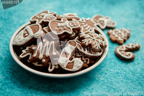 Image of Delicious fresh Christmas decorated gingerbread cookies placed in wooden crate