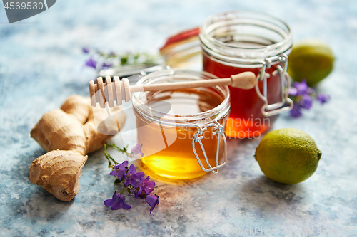 Image of Healthy food table with different kinds of honey, fresh ginger and lime