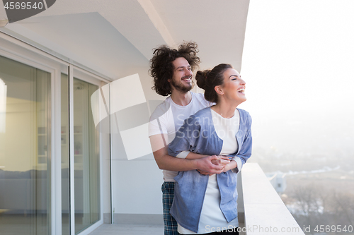 Image of Couple hugging on the balcony